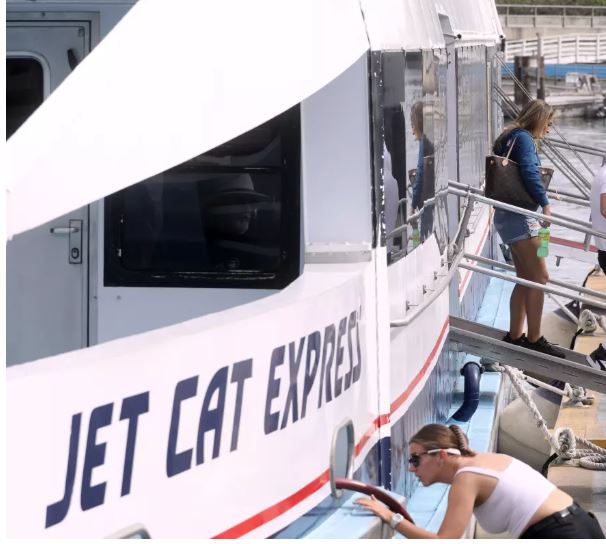 People walking off an express boat.